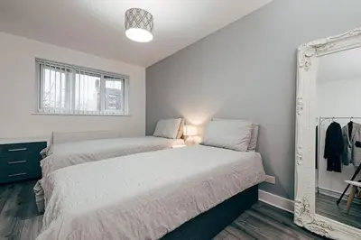 a bedroom with two beds and a mirror at Park & Relax in 1bd Central Liverpool home in Liverpool