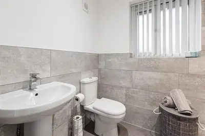 a bathroom with a white toilet and a sink at Park & Relax in 1bd Central Liverpool home in Liverpool