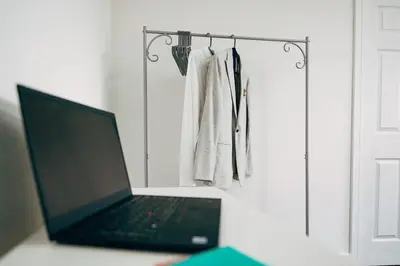 a laptop computer sitting on a desk next to a door at Park & Relax in 1bd Central Liverpool home in Liverpool