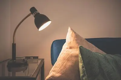 a pillow sitting on a couch next to a table with a lamp at Liverpool city centre house, Free parking in Liverpool