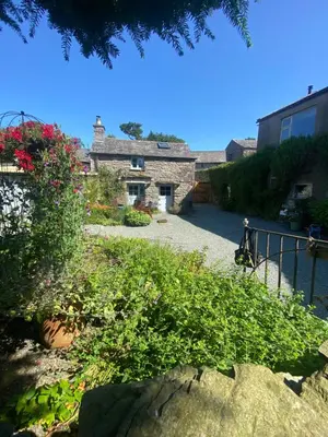 a house with a garden in front of it at Cartmel Barn: Beckside Stables in Cartmel