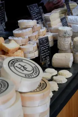 a display of different types of cheeses and bread at Cartmel Barn: Beckside Stables in Cartmel