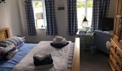 a bedroom with a bed with two towels on it at Brandreth Barn in Burscough