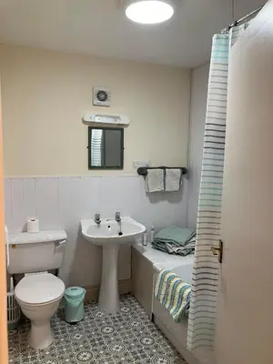 a bathroom with a toilet and a sink at Brandreth Barn in Burscough