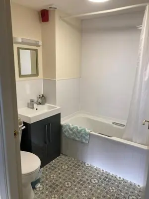 a bathroom with a toilet and a sink and a tub at Brandreth Barn in Burscough