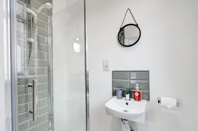 a white bathroom with a sink and a shower at Huge 5bedrooms/Ensuite/Liverpool/Ridley rd/Parking in Liverpool