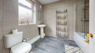 a bathroom with a toilet and a sink and a shower at Modernised 3-bedroom Blackburn townhouse sleeps 6 in Rishton