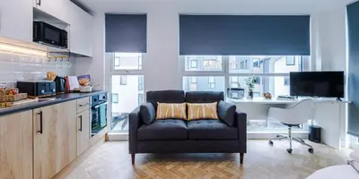 a living room with a couch in a kitchen at City Studios, Preston in Preston