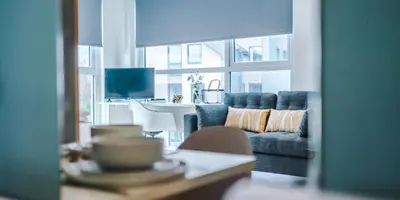 a living room with a blue couch and a table at City Studios, Preston in Preston