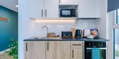 a kitchen with a sink and a microwave at City Studios, Preston in Preston