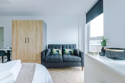 a living room with a couch in front of a window at City Studios, Preston in Preston