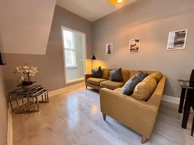 a living room with a couch and a table at Teds Apartments - Town Centre - Apt 1 in Blackpool
