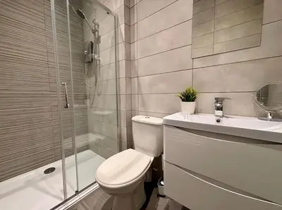 a bathroom with a toilet and a sink and a shower at Teds Apartments - Town Centre - Apt 1 in Blackpool