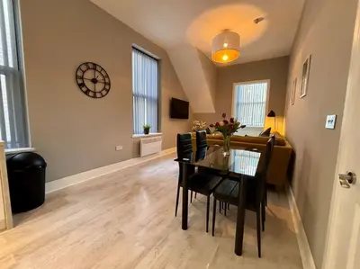 a living room with a table and a couch at Teds Apartments - Town Centre - Apt 1 in Blackpool