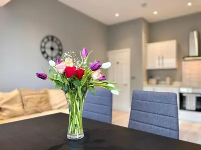 a vase of flowers sitting on a table in a kitchen at Teds Apartments - Town Centre - Apt 2 in Blackpool