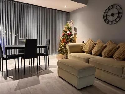 a living room with a christmas tree and a couch at Teds Apartments - Town Centre - Apt 2 in Blackpool