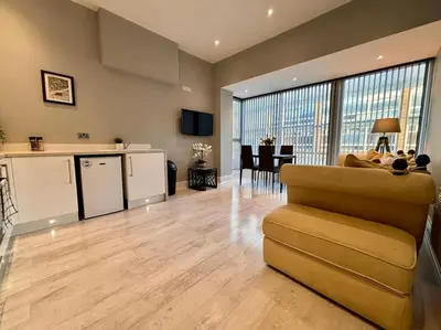 a large living room with a couch and a kitchen at Teds Apartments - Town Centre - Apt 2 in Blackpool