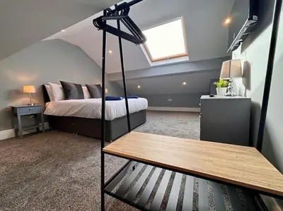 a bedroom with a bed and a table in it at Teds Apartments - Town Centre - Apt 3 in Blackpool