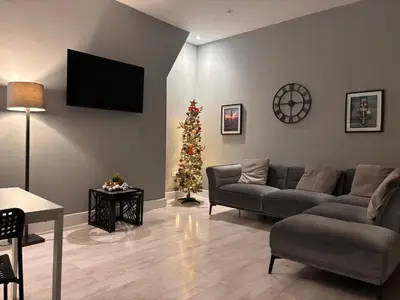 a living room with a couch and a christmas tree at Teds Apartments - Town Centre - Apt 3 in Blackpool