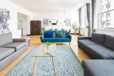 a living room with two couches and a blue couch at Host & Stay - Exchange Street Living in Liverpool