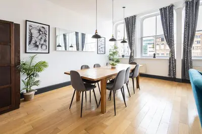 a dining room with a wooden table and chairs at Host & Stay - Exchange Street Living in Liverpool
