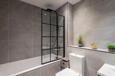 a bathroom with a shower and a toilet and a sink at Host & Stay - Exchange Street Living in Liverpool