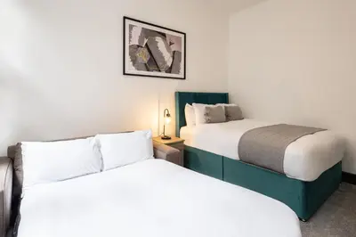 two beds in a small room with white walls at Host & Stay - Exchange Street Living in Liverpool