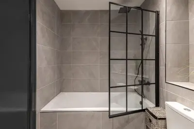 a shower with a white tub in a bathroom at Host & Stay - Exchange Street Living in Liverpool