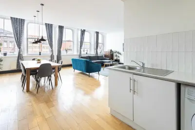 a kitchen and living room with a table and chairs at Host & Stay - Exchange Street Living in Liverpool