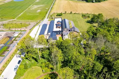 an aerial view of a large house in a field at Home Farm Cottage in Lytham St Annes