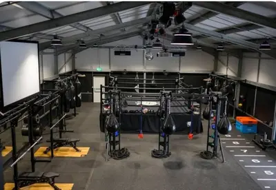 a room with a gym with lots of boxing equipment at Home Farm Cottage in Lytham St Annes