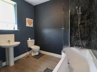 a bathroom with a sink and a toilet and a shower at Pendle View Apartments in Blackburn
