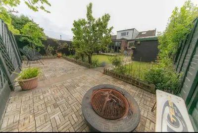 a patio with a grill in the middle of a yard at Beautifully styled Home with Garden in Poulton le Fylde