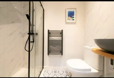 a bathroom with a shower and a toilet and a sink at Beautifully styled Home with Garden in Poulton le Fylde