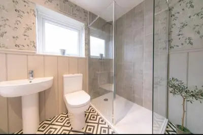 a bathroom with a toilet and a sink and a shower at Beautifully styled Home with Garden in Poulton le Fylde