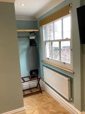 a hallway with a window and a radiator at Aachen Hotel in Liverpool