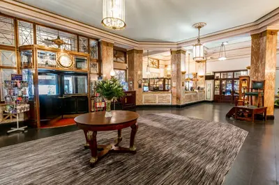a large room with a table and a rug at Adelphi Hotel in Liverpool