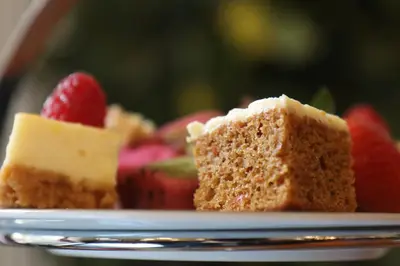 a piece of cake on a plate with strawberries at Adelphi Hotel in Liverpool