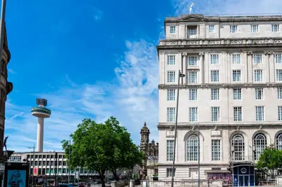 a large white building with a tower in front of it at Adelphi Hotel in Liverpool