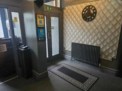 a hallway of a building with a door and a door sidx sidx at ROSE in Blackpool