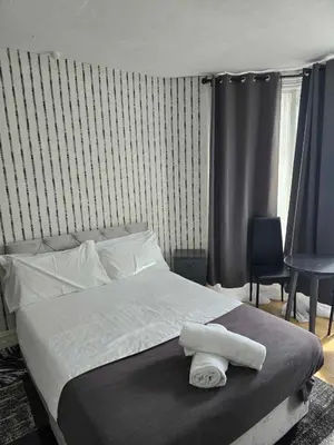 a bedroom with a bed with two towels on it at ROSE in Blackpool