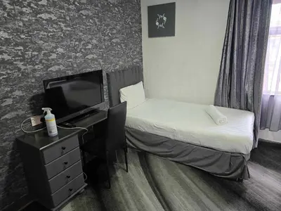 a hotel room with a bed and a television at ROSE in Blackpool