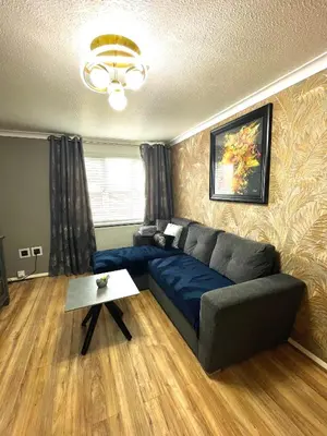 a living room with a couch and a table at Modern Luxury apartment Liverpool in Liverpool