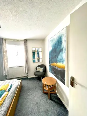 a bedroom with a bed and a chair and a window at Modern Luxury apartment Liverpool in Liverpool
