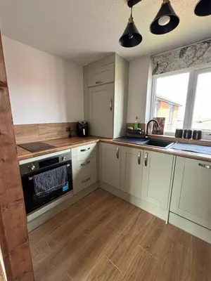 a kitchen with white cabinets and a black dishwasher at Modern Luxury apartment Liverpool in Liverpool