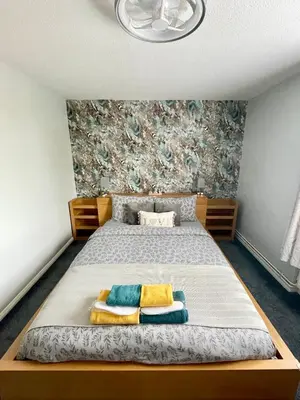 a bedroom with a bed with two pillows on it at Modern Luxury apartment Liverpool in Liverpool