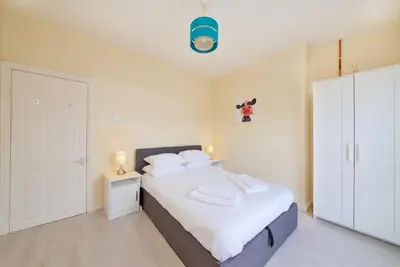 a bedroom with a bed with white sheets and white pillows at GuestReady Modern 2BR Home by Anfield Stadium in Liverpool
