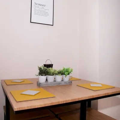 a wooden table with three potted plants on it at GuestReady Modern 2BR Home by Anfield Stadium in Liverpool
