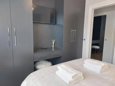 a bedroom with a bed with two white towels on it at Sunnydale, Cartmel in Cartmel