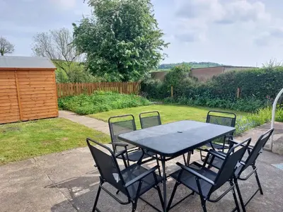 a black table and chairs in a yard at Sunnydale, Cartmel in Cartmel